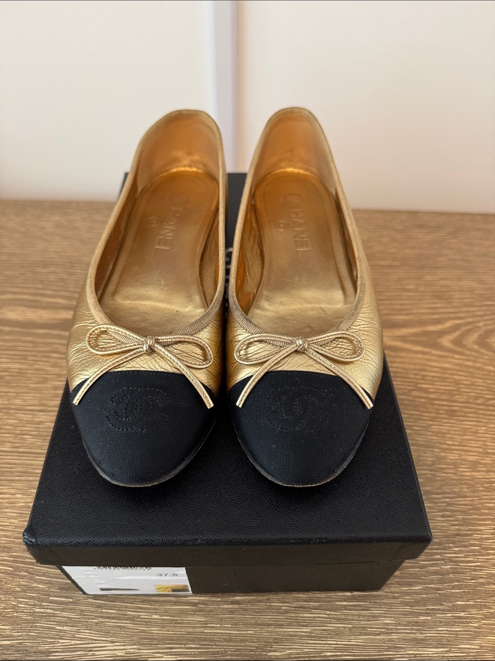 CHANEL Gold Leather Ballet Flats with Black Cap-Toe